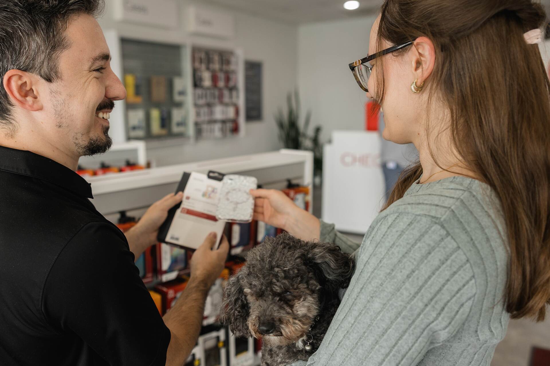 A MyRepairStore technician showing a repair option to a customer in the store